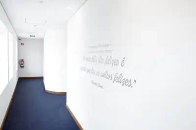 a hallway with a wall with writing on it at Oca Ribeira do Porto Hotel in Porto