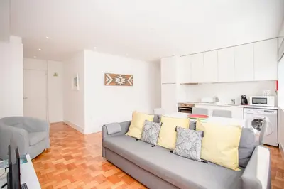 a living room with a couch and a kitchen at Liiiving in Porto - Sunny Santa Catarina in Porto