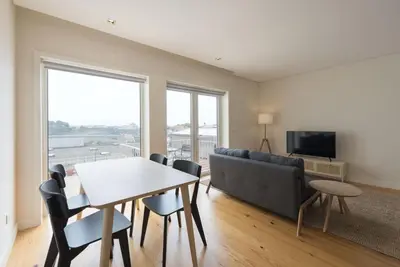 a living room with a table and a couch at BmyGuest - São Vitor Balcony Apartment in Porto