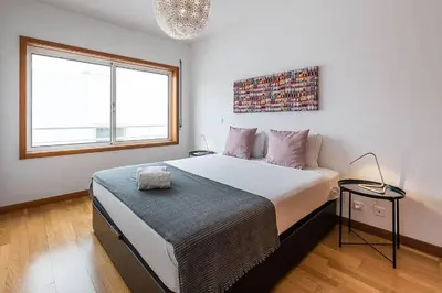 a bedroom with a large bed and a window at Loulé 246 · 1 bedroom apartment · Parking in Porto
