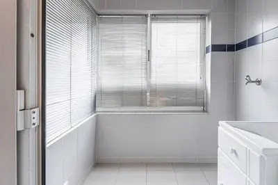 a white bathroom with a tub and a window at Loulé 246 · 1 bedroom apartment · Parking in Porto
