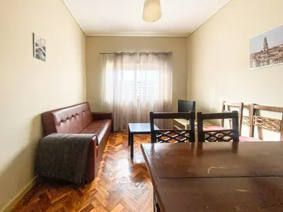 a living room with a couch and a table at Convenient 3-Bedroom Apartments next to Bom Sucesso in Porto