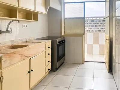 a kitchen with a sink and a stove at Convenient 3-Bedroom Apartments next to Bom Sucesso in Porto