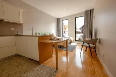 a kitchen with a wooden table in a room at Oporto Trendy Formosa in Porto