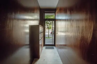 a hallway with a yellow door and a mirror at Bright Boavista by Vacationy in Porto