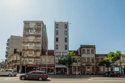 a street with buildings and a car parked on a street at Bright Boavista by Vacationy in Porto