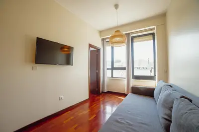 a room with a table and chairs and a couch at Bright Boavista by Vacationy in Porto