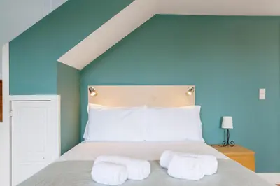 a bedroom with a bed with two towels on it at CLUBE Charming Apartments - São Bento in Porto