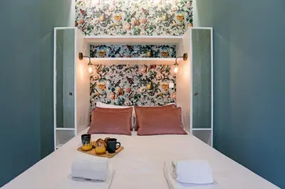 a bed with a headboard with a tray of fruit on it at Turquoise Central Flat w AC & Balcony by LovelyStay in Porto
