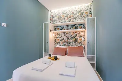 a small bedroom with a bed with towels on it at Turquoise Central Flat w AC & Balcony by LovelyStay in Porto