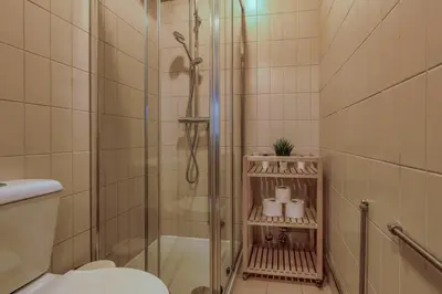 a bathroom with a shower and a toilet at Travel and Live Faria Guimarães in Porto