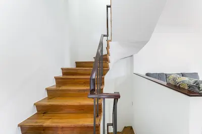 a staircase in a house with wooden floors and white walls at GuestReady - Modern Duplex, Neo-Classical Building in Porto