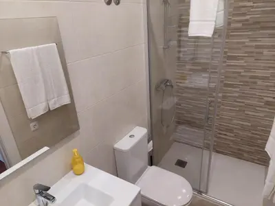 a bathroom with a shower and a toilet and a sink at Cool Suites in Porto
