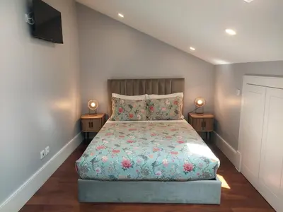 a bedroom with a bed and two night stands at Cool Suites in Porto