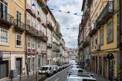 a row of cars parked on a street with buildings at ICON Duplo Ribeira in Porto