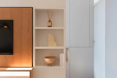 a book shelf with a pot and a vase on it at Tripas-Coração, Almada Charming City Center in Porto
