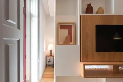 a living room with a tv on a wall at Tripas-Coração, Almada Charming City Center in Porto