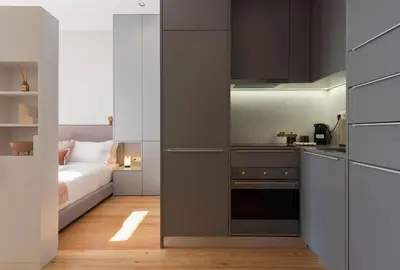 a small kitchen with a bed in a room at Tripas-Coração, Almada Charming City Center in Porto