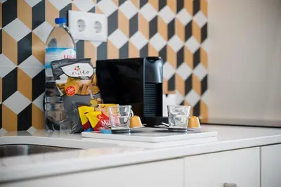 a counter top with a computer and glasses on it at Chimney Luxury House with AC in Porto