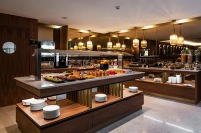 a restaurant with a buffet with food on display at TURIM Oporto Hotel in Porto