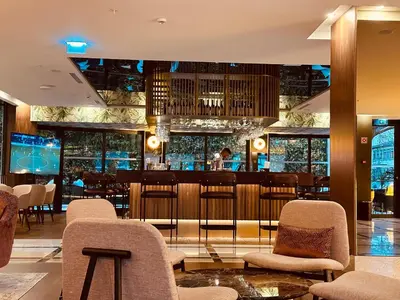 a restaurant with chairs and a bar at TURIM Oporto Hotel in Porto