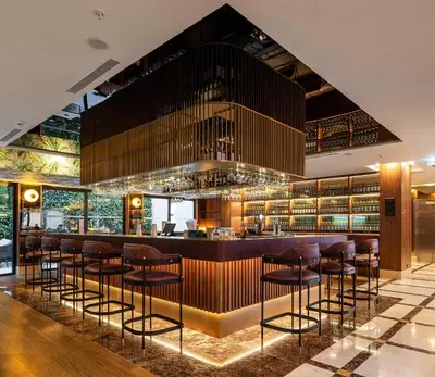 a bar with brown stools in a restaurant at TURIM Oporto Hotel in Porto