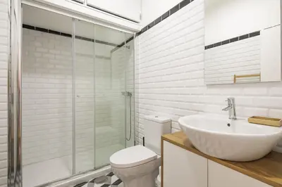 a bathroom with a toilet and a sink and a shower at Virtudes Flat in Porto