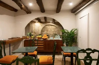 a room with tables and chairs and a counter at Almadina Smart Luxury in Porto