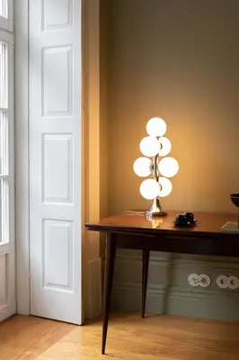 a lamp sitting on a table next to a door at Almadina Smart Luxury in Porto