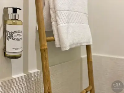 a towel rack with a bottle of soap on it in a bathroom at 115 OPorto Guest House in Porto