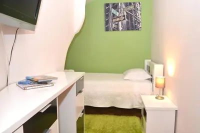 a bedroom with a bed and a desk with a tv at Casa do Mirante in Porto