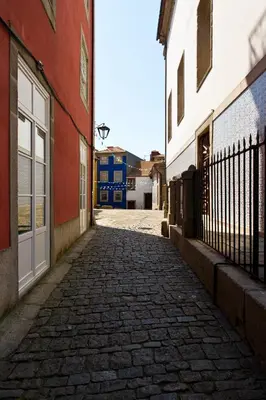 a cobblestone street in an alley between two buildings at BOUTIQUE Rentals- DOURO Ribeira historical center with parking in Porto