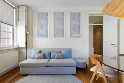 a living room with a blue couch and a table at BOUTIQUE Rentals- DOURO Ribeira historical center with parking in Porto