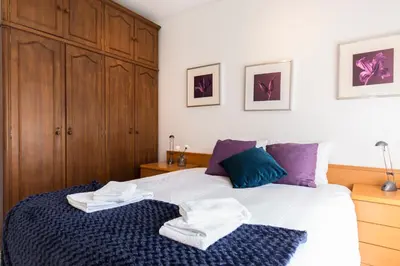 a bedroom with a bed with towels on it at Metro Lapa House with sunny balcony and A/C in Porto