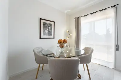 a dining room with a glass table and chairs at GuestReady - Amazing stay near Cedofeita Church in Porto