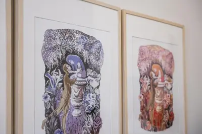 a pair of paintings of a woman on a wall at GuestReady - Amazing stay near Cedofeita Church in Porto