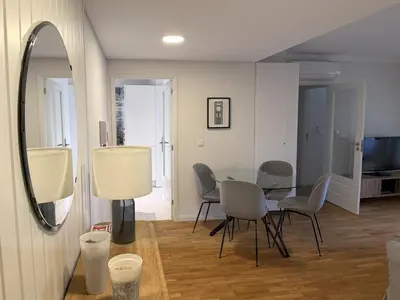 a dining room with a table and chairs and a mirror at Atayde da Câmara - Porto in Porto