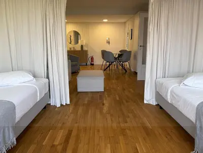 a hotel room with two beds and a table at Atayde da Câmara - Porto in Porto