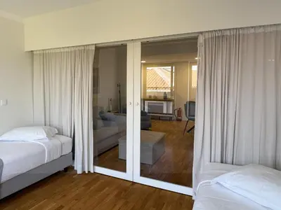 a bedroom with two beds and a living room at Atayde da Câmara - Porto in Porto