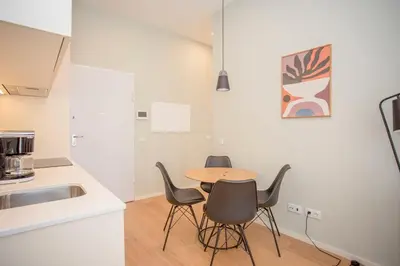 a white bedroom with a bed and a mirror at Liiiving in Porto - Sweet Sunlight Apartment in Porto