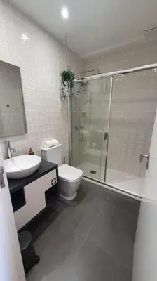 a bathroom with a toilet sink and a shower at Glamour Dreaming Studio in Porto