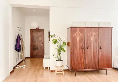 a room with a wooden cabinet and a potted plant at Central Loft with free parking in Porto