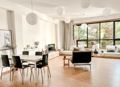 a living room with a table and chairs at Central Loft with free parking in Porto