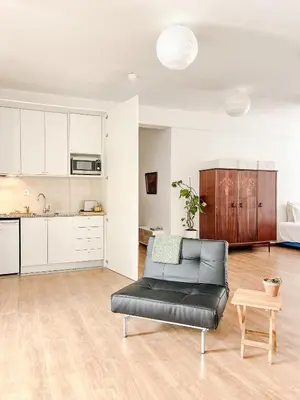 a white shelf with flowers and vases on it at Central Loft with free parking in Porto