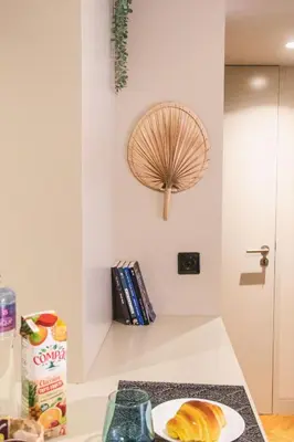 a kitchen counter with a plate of food and a fan on the wall at São Lázaro's Garden - Apartment With Terrace in Porto