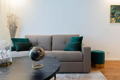 a living room with a couch and a table at Stunning Apartment w/ Free Parking by LovelyStay in Porto