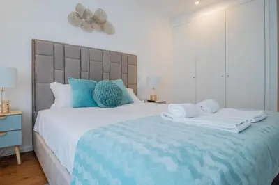 a bedroom with a large bed with towels on it at Stunning Apartment w/ Free Parking by LovelyStay in Porto