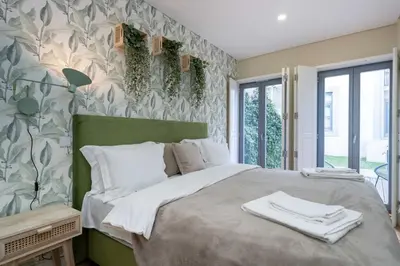 a bedroom with a bed with towels on it at Formosa Apartments by Amber Star Rent in Porto