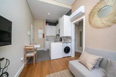 a living room with a couch and a kitchen at Formosa Apartments by Amber Star Rent in Porto