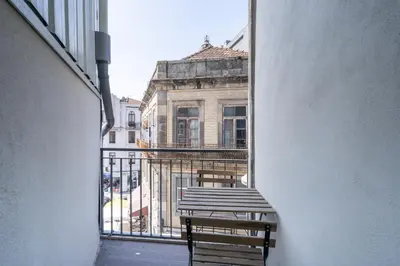 an empty balcony with two benches and a building at Formosa Apartments by Amber Star Rent in Porto